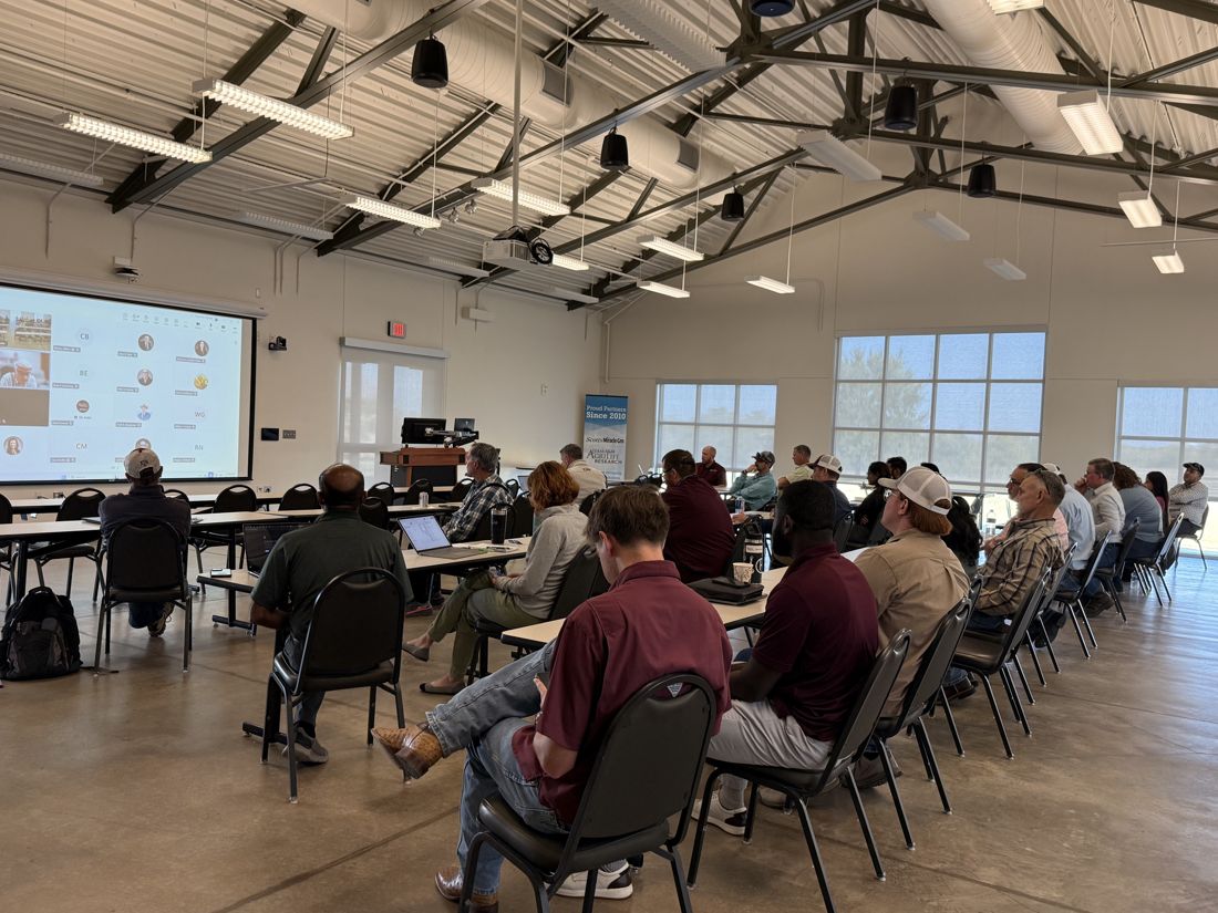 Audience of extension specialists and growers listening to a talk